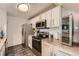 Well-lit kitchen with white cabinets, stainless steel appliances, and updated countertops at 9510 E Florida Ave # 3055, Denver, CO 80247