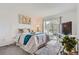 Relaxing bedroom features a sliding door to a balcony and large window at 9510 E Florida Ave # 3055, Denver, CO 80247