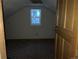 Bedroom with a small window and wood door at 1805 Hidden Valley Rd, Sedalia, CO 80135