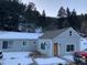 Charming house with snow-covered yard at 1805 Hidden Valley Rd, Sedalia, CO 80135
