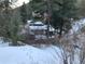 A hillside view of the home from the surrounding forest landscape at 1805 Hidden Valley Rd, Sedalia, CO 80135