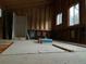 Unfinished living room area with wood walls and ceilings featuring large windows providing natural light at 1805 Hidden Valley Rd, Sedalia, CO 80135