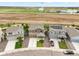 Aerial view shows three homes in a row; center home has neat yard and long driveway at 47312 Lilac Ave, Bennett, CO 80102