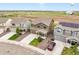 Aerial view of home featuring landscaped front yard, large driveway, and a red vehicle parked out front at 47312 Lilac Ave, Bennett, CO 80102