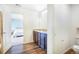 Bathroom exhibiting a dual sink vanity with granite counters, wood-look floors and a toilet at 47312 Lilac Ave, Bennett, CO 80102