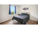 Bedroom showcasing a bed with views of the outdoor landscape through the window at 47312 Lilac Ave, Bennett, CO 80102