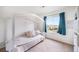 A bedroom showcasing a daybed with throw pillows next to a window with blue curtains at 47312 Lilac Ave, Bennett, CO 80102