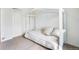 Bedroom features a daybed with throw pillows and a white frame against neutral-colored carpet at 47312 Lilac Ave, Bennett, CO 80102