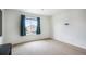Well-lit bedroom featuring a large window with green curtains and ample space at 47312 Lilac Ave, Bennett, CO 80102