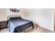 Bedroom exhibiting a bed and an accent picture with dark bedding in a well-lit space at 47312 Lilac Ave, Bennett, CO 80102