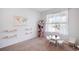 Bright bedroom featuring a small table with chairs, a world map, and wooden shelves for a -friendly space at 47312 Lilac Ave, Bennett, CO 80102