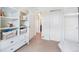 ' bedroom features white bookshelf, closet, and neutral carpet; bedroom connects to a bathroom at 47312 Lilac Ave, Bennett, CO 80102