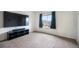 Bright bedroom featuring a large window, dark curtains, and a media center for entertainment at 47312 Lilac Ave, Bennett, CO 80102