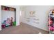 Bedroom view showcasing closet storage solutions, complemented by a world map and floating shelves at 47312 Lilac Ave, Bennett, CO 80102