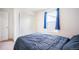 Bedroom displaying a cozy bed next to the window with curtains and a closet at 47312 Lilac Ave, Bennett, CO 80102