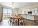 Dining area with hardwood floors, a view to the living area, and a sliding glass door at 47312 Lilac Ave, Bennett, CO 80102