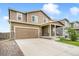 Charming two-story home with a spacious two-car garage and welcoming front porch at 47312 Lilac Ave, Bennett, CO 80102