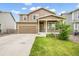 Traditional two-story home with an attached garage and well-manicured lawn at 47312 Lilac Ave, Bennett, CO 80102