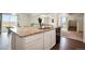 View of the open kitchen with island, with a view of the living room and stairs at 47312 Lilac Ave, Bennett, CO 80102