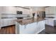 Modern kitchen featuring white cabinetry, stainless steel appliances, and a large island at 47312 Lilac Ave, Bennett, CO 80102