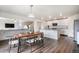 Open concept living area with kitchen island, hardwood floors, and a view of the living room at 47312 Lilac Ave, Bennett, CO 80102