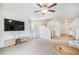 Inviting living room with neutral carpet, a ceiling fan, and modern furnishings at 47312 Lilac Ave, Bennett, CO 80102