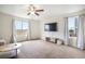 Bright living room with a ceiling fan, large windows, and ample natural light at 47312 Lilac Ave, Bennett, CO 80102