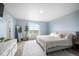 Serene main bedroom with a plush bed, full length mirror, and bright natural light at 47312 Lilac Ave, Bennett, CO 80102