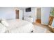 Main bedroom with walk-in closet, TV, dresser, and full-length mirror for convenience at 47312 Lilac Ave, Bennett, CO 80102