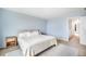 Relaxing main bedroom featuring a comfy bed, stylish side table, and soft blue walls at 47312 Lilac Ave, Bennett, CO 80102