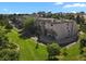 Scenic aerial perspective of the condo buildings surrounded by greenery, landscaping, and mature trees at 7000 E Quincy Ave # 302, Denver, CO 80237