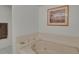 Bathroom with a soaking tub, tile surround, and decorative accessories at 7000 E Quincy Ave # 302, Denver, CO 80237