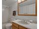 Functional bathroom with a mirrored medicine cabinet, tub, and neutral finishes at 7000 E Quincy Ave # 302, Denver, CO 80237