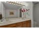 Bright bathroom with double sink vanity, large mirror with Hollywood lights, and decorations at 7000 E Quincy Ave # 302, Denver, CO 80237