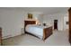 Spacious bedroom with natural lighting, wood furniture, and light colored carpet at 7000 E Quincy Ave # 302, Denver, CO 80237