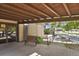 Welcoming covered entrance featuring a bench, accessible ramp, and views of the surrounding greenery at 7000 E Quincy Ave # 302, Denver, CO 80237