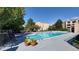 Outdoor community pool with lounge chairs and shade from mature trees at 7000 E Quincy Ave # 302, Denver, CO 80237