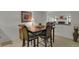 This dining room features a wooden table, chairs with patterned cushions, artwork, and views to the nearby living room at 7000 E Quincy Ave # 302, Denver, CO 80237