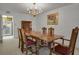 The formal dining area, illuminated by a chandelier, is conveniently located near the kitchen for easy meal service at 7000 E Quincy Ave # 302, Denver, CO 80237