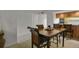 This dining room features a wooden table, chairs with patterned cushions, and easy access to both the kitchen and living room at 7000 E Quincy Ave # 302, Denver, CO 80237