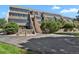 A multistory condominium complex with modern architecture, featuring a lush green landscape at 7000 E Quincy Ave # 302, Denver, CO 80237