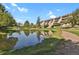 Peaceful community with serene pond and beautiful landscaping surrounding the building at 7000 E Quincy Ave # 302, Denver, CO 80237