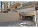 Street view of garage entrance, built into condo building in neutral concrete at 7000 E Quincy Ave # 302, Denver, CO 80237