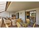 Living room features a sitting area with wicker furniture and a glass table next to sliding glass doors at 7000 E Quincy Ave # 302, Denver, CO 80237