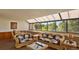 Bright living room with wicker furniture and large windows overlooking a park at 7000 E Quincy Ave # 302, Denver, CO 80237