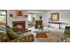 The living room includes a fireplace, comfortable seating, and access to an outdoor patio that enhance the living experience at 7000 E Quincy Ave # 302, Denver, CO 80237