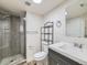 Bathroom featuring a glass enclosed shower, modern vanity, and sleek fixtures at 5665 Niagara St, Commerce City, CO 80022