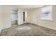 Bedroom featuring entryways to a closet and bathroom with plush gray carpet at 5665 Niagara St, Commerce City, CO 80022