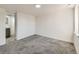 Bedroom featuring an attached room with carpet and white-painted brick walls at 5665 Niagara St, Commerce City, CO 80022