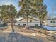 Exterior of home with mature trees and gravel landscaping at 5665 Niagara St, Commerce City, CO 80022